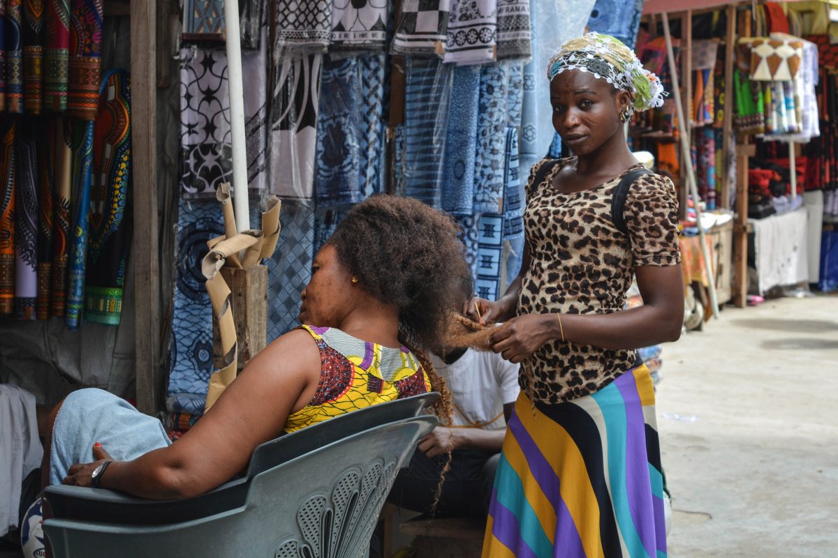Africa - Hair braiding at Makola Market in Accra, the capital of Ghana