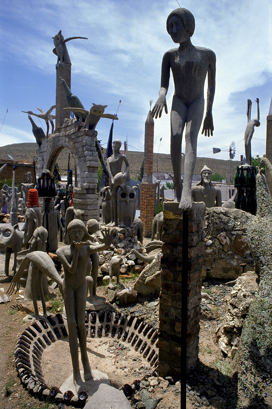 Fantastical concrete scultures in the Camel Yard of the Owl House in Nieu-Bethesda, a small farming town in the southwest of the Eastern Cape. Created by artist Helen Martins in the 1950s, and from the 1960s in collaboration with Koos Malgas, the Owl House is a masterwork of visionary outsider art. The life of Helen Martins inspired "The Road to Mecca" by celebrated South African playwright Athol Fugard. Tourists drawn to Nieu-Bethesda to see the Owl House have revived the fortunes of the town. (South African Tourism, CC BY 2.0)